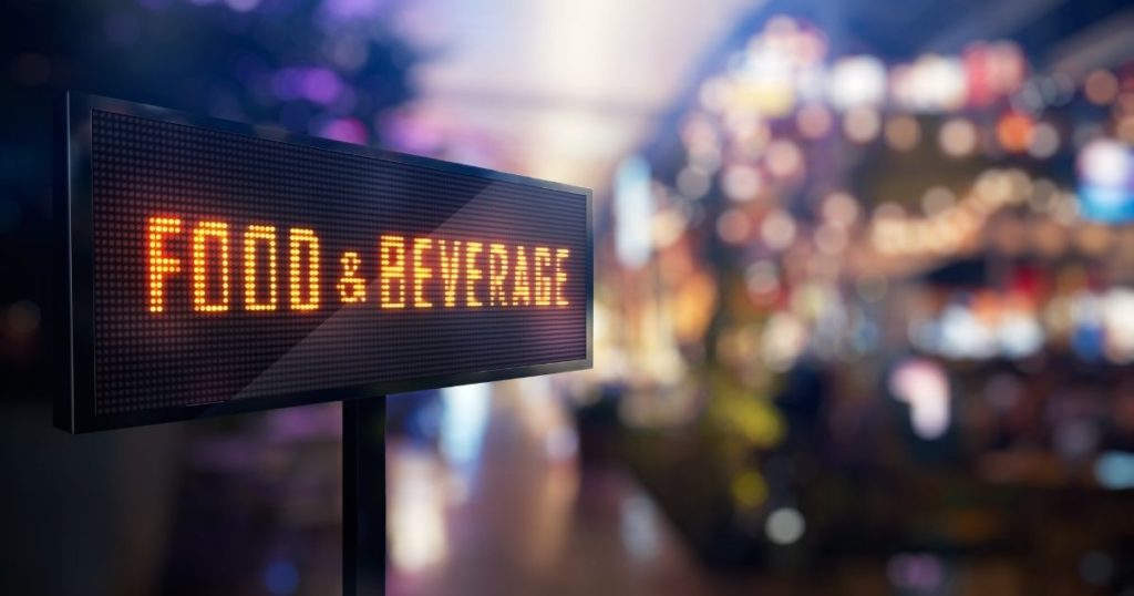 A digital sign displaying food & beverage at a sustainable event