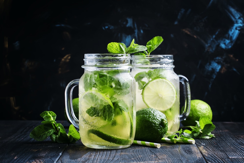 Iced mojito with lime and mint in glass jars