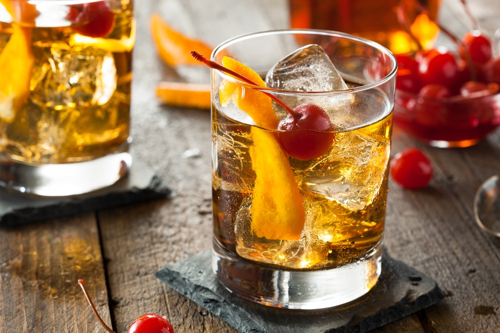 old-fashion cocktail with a cherry and orange
