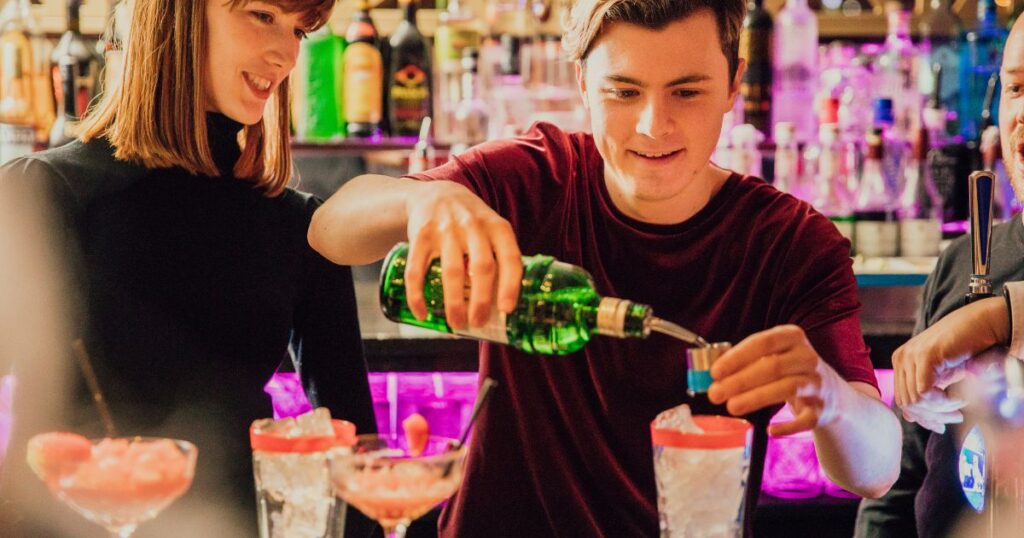 Staff making cocktails at a Christmas cocktail making party