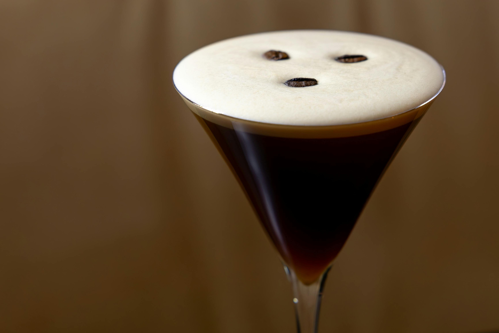 Espresso martini served in a classic cocktail glass with a creamy top and coffee bean garnish