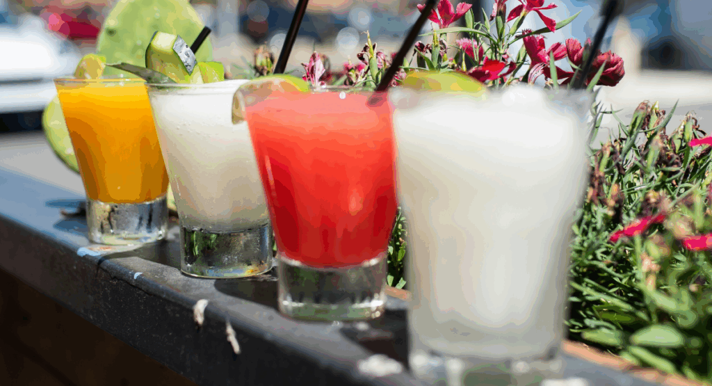 A series of 4 fresh cocktails lined up in a row