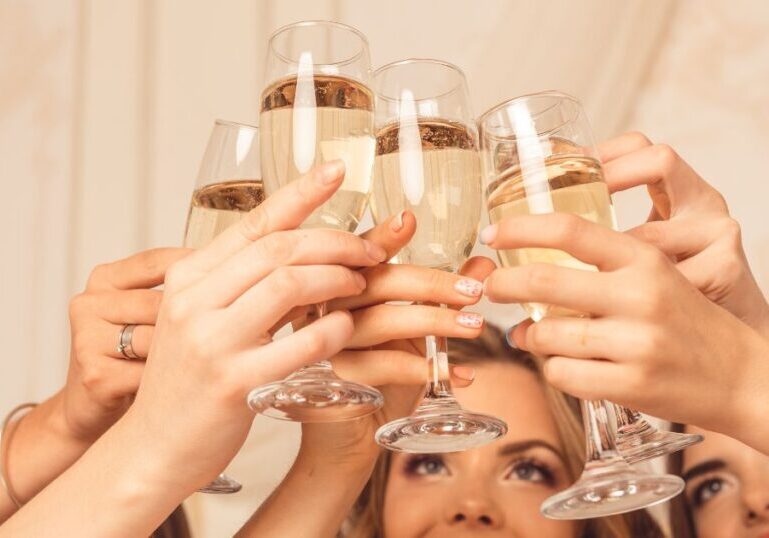 Clinking glasses at a backyard engagement party